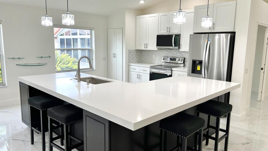 Completely renovated, brand new Porcelain Tile and baseboards throughout, new Cabinets, fresh new Quartz, new frig, dishwasher, oven, micro, wash/dryer + hot water heater! New motor A/C, oversized gorgeous kitchen island. Home is light and bright w/ all new LED lighting. Primary Bedroom features stunning new chandelier and two large walk-ins. Primary Bath w/ two new vanities, new toilet, large tub for soaking, white tile shower. New Guest Bath Shower with Porcelain tiled walls, new frame-less glass shower door, new vanity/sink and toilet. Quiet cul-de-sac. Screened Patio private tropical paradise w/ tranquil waterfall & pond. Buyer's choice of exterior paint. HOA incl. lawn service, manned gate-Cascades has pool, tennis, gym, cafe, card/billiard rm, shows, pickle ball & much more