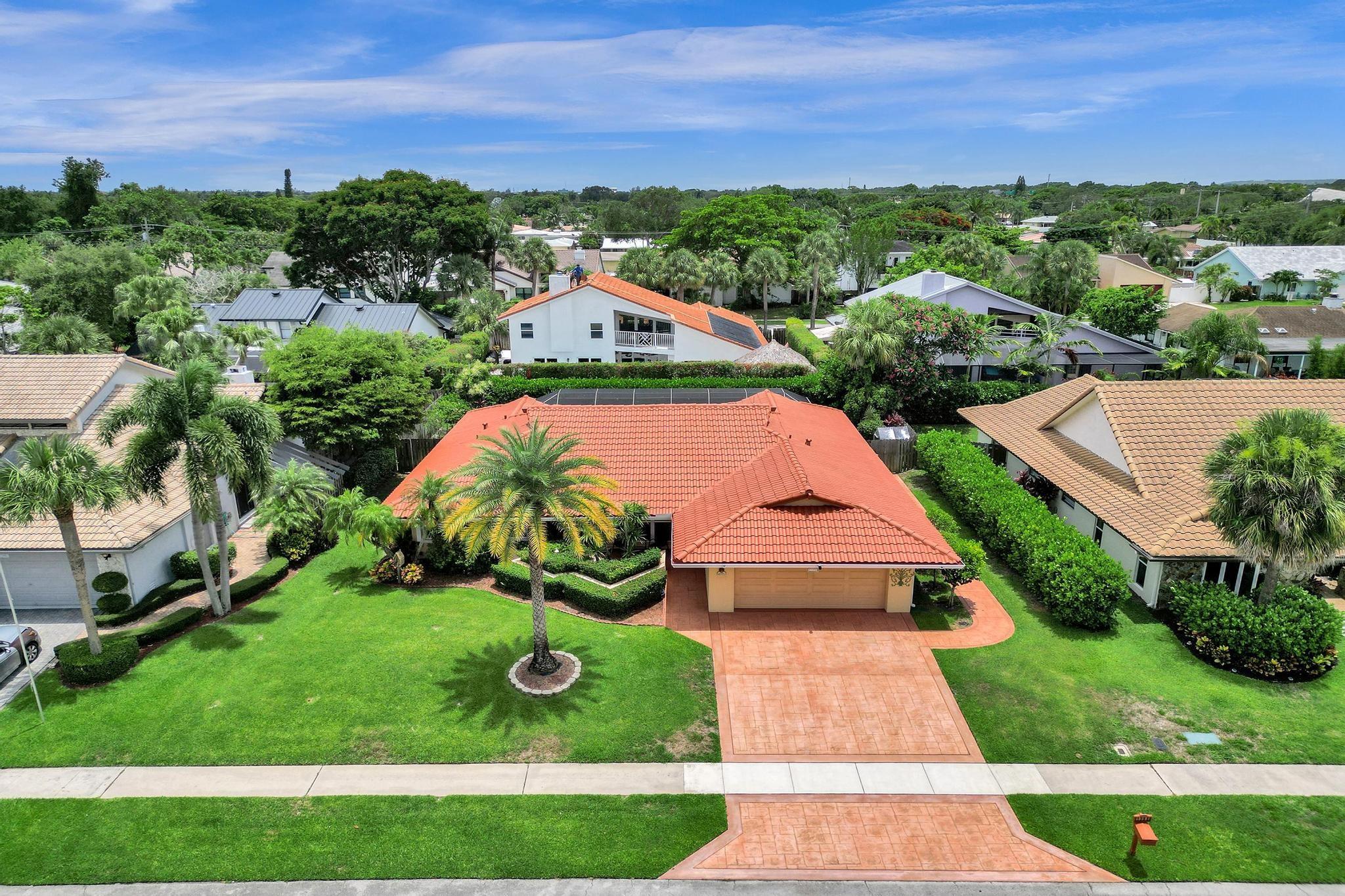 Location, Location, Location! This 4-bed, 2-bath pool home is just steps away from Addison Mizner Elementary, just east of Sugar Sand Park and I-95 and minutes away from Brightline, Mizner Park, Boca Regional Hospital, the beach, FAU, and Lynn University. Zoned for A-rated schools and located in a highly desirable, no-HOA neighborhood. Features include hurricane-impact windows, doors, and garage door, real wood floors, split floor plan, screened-in pool and patio, lush private yard with clusia hedges, full-house generator, new pool pump, and accordion shutters for extra protection. Whether you're commuting, heading to class, dining, shopping, or enjoying the South Florida lifestyle, this location is perfect! Rare opportunity to live where convenience, community, and value come together!