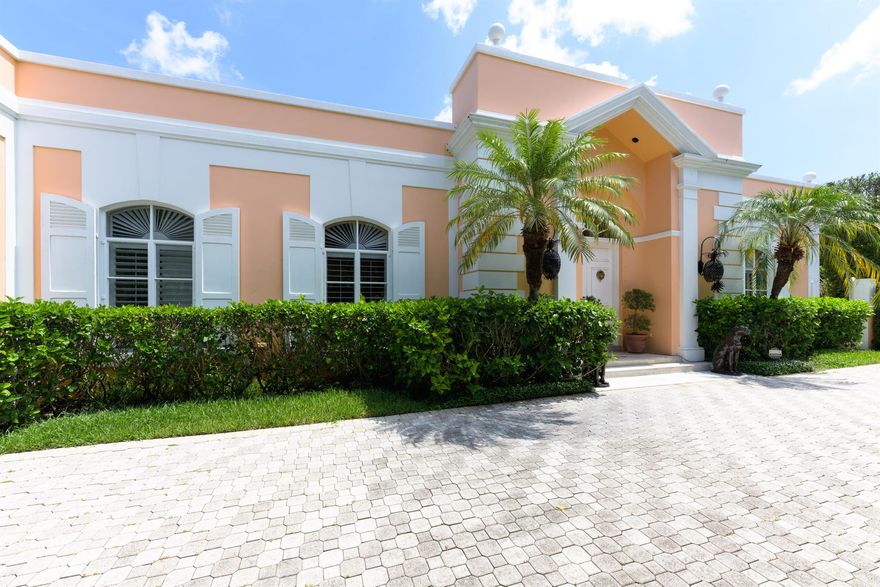 Elegant abounds in this classic Gottfried designed sun filled 5 Bedroom 4/2.5 Bath, plus office or staff room, with 12 foot ceilings situated on a high elevation over 14,800 sq. ft. lot on a quiet cul de sac just South of The Royal and the Flagler Museum.  With gorgeous marble floors, wood burning fireplace, tres chic center courtyard for al fresco dining accessed via glass sliding doors from the main living areas to the canopied patio/loggia this house is truly a rare find!   Fabulous 14 x 40 ft. pool, two car garage with Tesla plug in, Katolight, 40kw full house generator, and electric shutters.  Best location in town, between the bridges,  and close to The Breakers and the Four Arts too!