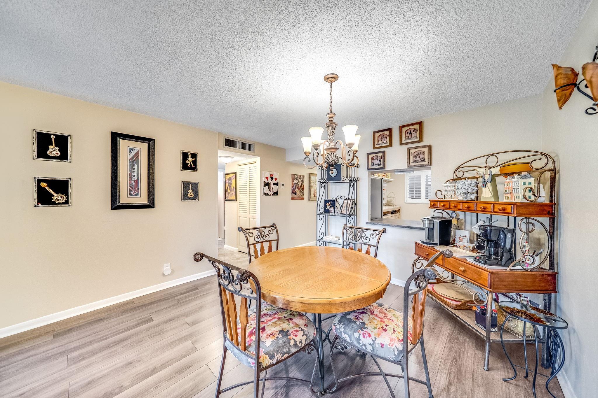 UPGRADES GALORE! 2bed/2 bath, largest unit, in the desirable and highly sought after Holiday Springs Village 4! IMPACT WINDOWS! All tile and laminate throughout, new refrigerator, AC- 2 years new. Both showers, re-done with Bath Fitters! New Plantation shutters in the living room and kitchen. Rolladen shutters on screened in patio. Lowest HOA for 2-bedroom units in Holiday Springs! New roof coming, already approved and included in budget, NO assessment. Tons of storage including walk in closets. Excellent reserves! Community Laundry just put in all new washing machines and dryers! Assigned parking. Private pool in addition to the main clubhouse pool. Both bedrooms furniture negotiable. Enjoy the active lifestyle of fun, fitness, friends, laughter and live entertainment at your doorstep!