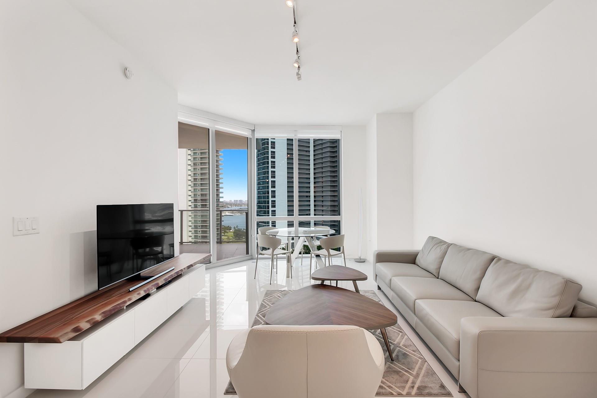 Modern design decorated and furnished residence in Paramount Worldcenter. Best line in the building with ocean views. One bedroom plus den or second bedroom with a large balcony. 10ft ceilings. Features white porcelain floors and open European kitchen with wolf appliances, sub zero refrigerator, laundry room with washer and dryer. Paramount amenities include concierge, tennis, basketball, soccer field, boxing ring, gym, game tables, movie theater, mini golf, kids room, spa, 3 resort style pools and 58th floor pool with 360 views.