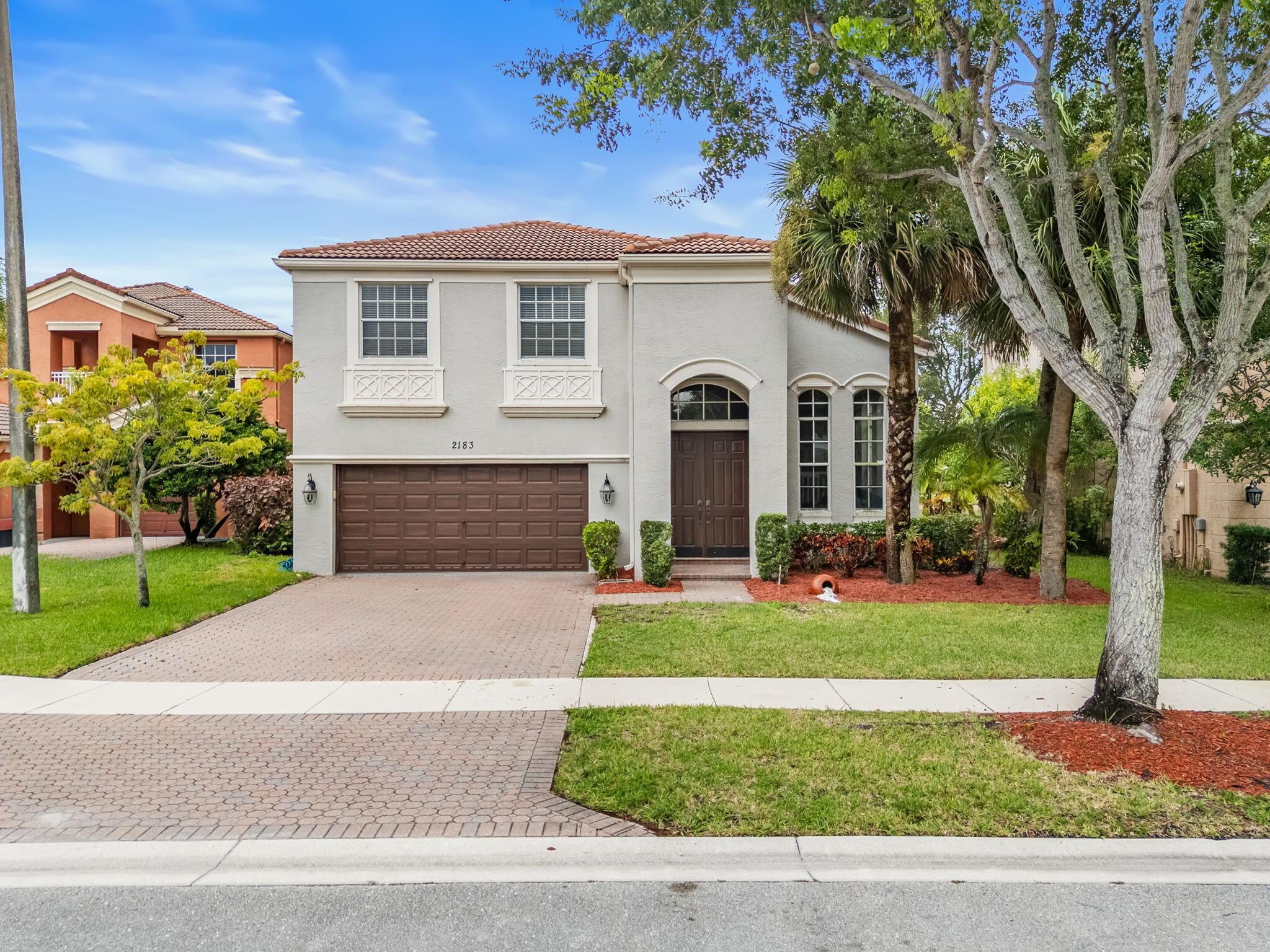 Welcome to this beautiful Mediterranean-style home located in the highly sought-after gated community of Olympia in Wellington. Built in 2003, this two-story residence offers nearly 2,800 square feet of comfortable living space with four bedrooms and three full bathrooms, including a spacious upstairs master suite and a first-floor guest room that can easily serve as a private office. The home's thoughtful floor plan features a formal living room, dining room, family room, and an open kitchen with ample space for both entertaining and everyday living. Upstairs, the oversized master retreat provides a peaceful escape, while additional bedrooms are generously sized. The home sits on a beautifully landscaped .16 acre waterfront lot and offers tranquil lake views.