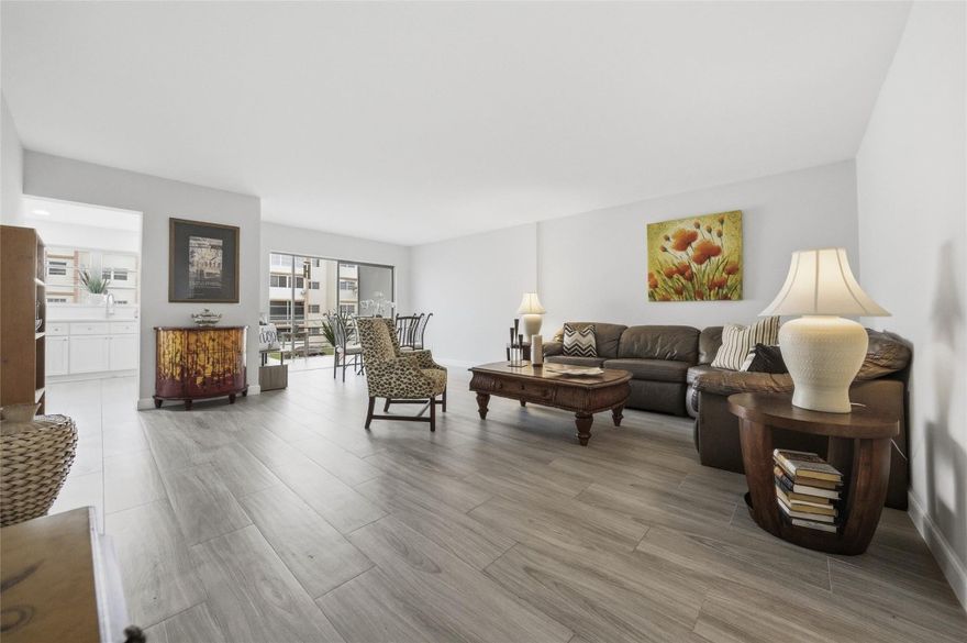 Welcome home to this gorgeous unit, Highly upgraded and completely remodeled to perfection!! Priced to sell quickly! New Tile floors throughout, New Kitchen cabinets, New Appliances, Quartz countertops, New Bathroom, Large bedroom with 2 closets one is a walk-in. Open floor plan with a screened terrace, Laundry by unit, Parking spot in front.  Secured building, unit is by the Elevator. Ideally located close to A rated school and middle school. Nothing to do, just move in and enjoy!! Ideal for year around or a winter getaway!! Renovations underway in hallways and new roof.**SELLER WILL PAY SPECIAL ASSESSMENTS AT CLOSING**