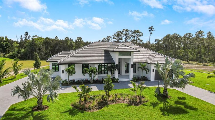 Absolutely stunning single-story 4 bedroom, 3.5 bath, 4 car garage 2022-build CBS home with full impact glass and doors! Sure to impress from the moment you arrive to the circular driveway and enter through the custom front door. The functional floor plan featuring a gracious foyer, formal dining area with wet bar and separate living area, work together with the abundance of natural lighting to create a spacious, yet serene and welcoming ambiance. The well appointed gourmet kitchen showcases custom high-end cabinetry, a gorgeous oversized island with added storage, dual sinks with separate prep areas, an abundance of counter space and spacious walk-in pantry.