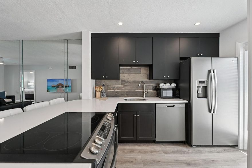 ALL ASSESSMENTS PAID! All systems 15+years+ on ALL SYSTEMS! Modern coastal living-Turn-key furnished & upgraded-full impact windows and doors, including all-glass entries. A bright southern-exposed layout features an upgraded kitchen with 42'' cabinetry, stainless appliances, custom pantry, and large island. Vinyl flooring, modern baseboards, and impact sliders open to a screened terrace overlooking the pool. The serene primary suite offers terrace access, a renovated bath, and walk-in closet. Enjoy blackout shades, new AC, new water heater, Nest, and extras--separate bike storage plus three private storage units. This well-managed community offers ''private beach access''  heated pool, clubhouse, car wash area, and dockage up to 26 FT--steps to Lauderdale-by-the-Sea and Pompano Beach fun!