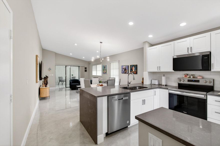 Discover refined living in this beautifully renovated 2-bedroom, 2-bath villa with garage located in the highly desirable 55+ gated community of Huntington Pointe. Thoughtfully redesigned and truly move-in ready, this home blends modern style with effortless comfort. At the heart of the residence is a stunning open-concept eat-in kitchen, featuring elegant quartz countertops, brand-new wood cabinetry, and a full suite of stainless-steel appliances, including a glass-top range, refrigerator, dishwasher, microwave, washer, and dryer. The spacious living areas are finished with luxurious 32'' porcelain tile flooring throughout, complemented by recessed lighting that brightens the kitchen and main living spaces. Both bathrooms have been fully remodeled with designer finishes, showcasing sleek  walk-in showers and contemporary fixtures that create a spa-like feel. A fully enclosed Florida room under air expands the living space and opens to a private side yard, offering the perfect setting for morning coffee, quiet relaxation, or entertaining guests. Located in the vibrant Huntington Pointe community, residents enjoy country club amenities, gated security, and an active lifestyle just minutes from shopping, dining, and entertainment. Turnkey villas with this level of renovation and a private garage are hard to find—schedule your private showing today.