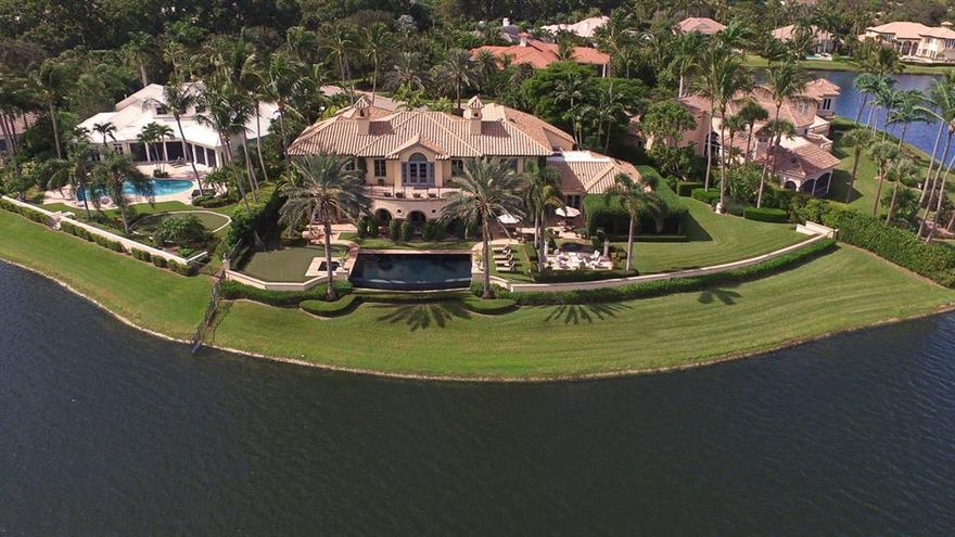 An award-winning home in an award-winning community. Situated on a premier lakefront lot with scenic panoramic golf course views, this magnificent grand estate home has received the highly coveted Prism Design Award for unique use of space, best custom home for its size and price range. Add this with the award-winning Loxahatchee Club, a Nicklaus Signature 18-hole course on 340 acres, plus 71 acres of fresh water lakes and 40 acres of greenbelt in an oasis nestled in Jupiter, Florida and you have a hole in one!