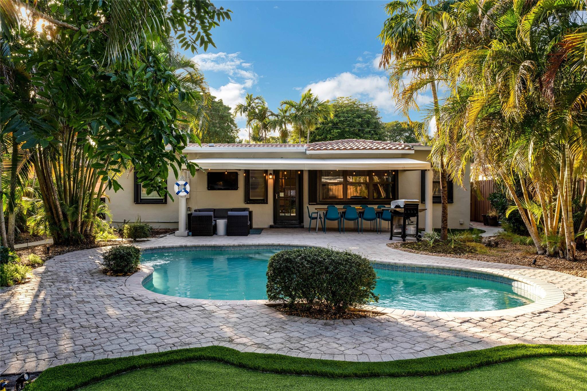 Beautifully landscaped and situated pool home with all the amenities centrally located close to the beach, downtown, Las Olas, Shopping and Dining! Four bedrooms / two bathrooms with an expansive living room overlooking a truly tropical private landscaped sanctuary(minimal maintenance designed) around a heated pool. Featuring, barrel tile roof, newer A/C, newer exterior awnings, impact glass, tile / wood floors, updated kitchen, LED recessed lighting, plantation shutters and large closets with extra storage nestled on one of the nicest streets in Poinsettia Heights. This is a perfect home for a primary residence, season residence or short term rental (previously operated as a licensed STR). Designer decorated and furniture is negotiable.