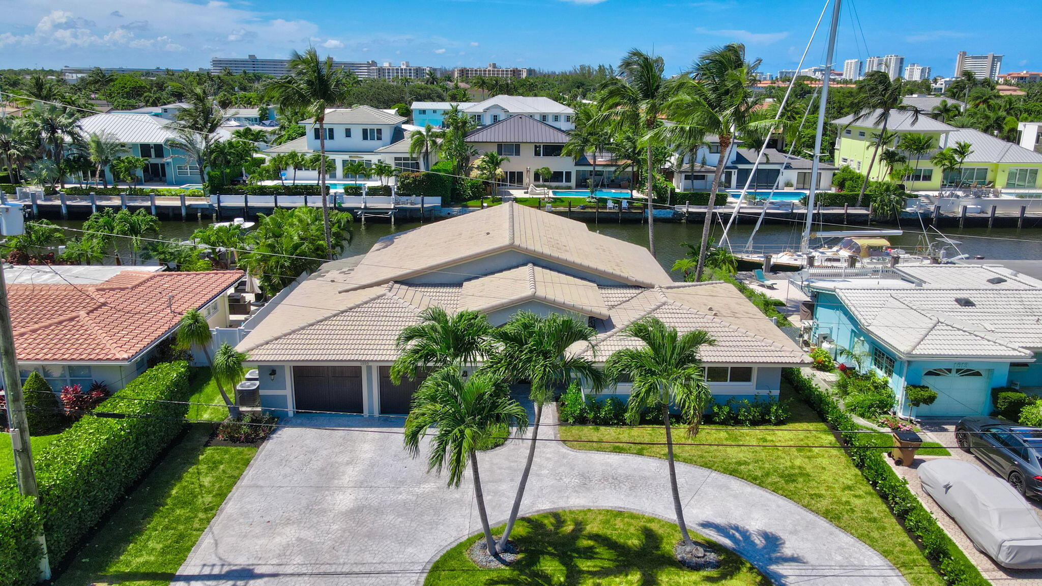 This beautiful 3-bedroom, 3-bath home is a true coastal gem, perfectly positioned on a wide canal along the Intracoastal Waterway. Situated in a no-wake zone with 80 feet of deep water dockage with no fixed bridge ocean access! Enjoy breathtaking panoramic water views from this open-concept interior featuring a split-bedroom layout, two spacious master suites with walk-in closets, and sleek porcelain tile flooring throughout. The chef's kitchen is equipped with top-of-the-line appliances. Additional features include a dual-zone A/C system, Ring security, a saltwater-chlorinated pool, a large circular driveway and custom mahogany double garage doors. Equipped with impact windows and doors and the freedom of NO HOA! Minutes from ''The Boca Raton'' and fine dinning, and the beach!