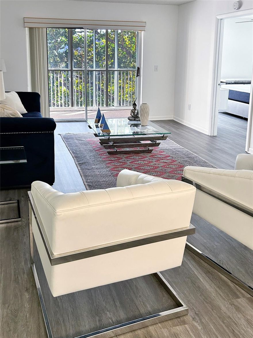 Rare opportunity to rent in a beautifully maintained 55+ guard-gated lakefront community. This bright and spacious 2-bedroom, 2-bath offers comfort, security, and the relaxed South Florida lifestyle tenants are looking for. The unit features ceramic tile and laminate flooring throughout the main living areas, laminate flooring in the bedrooms, ceiling fans, and vertical blinds. The home is partially furnished, making move-in simple and convenient. Enjoy one of the best features of the home, a large double-screened patio overlooking the lake, perfect for morning coffee, evening breezes, or entertaining guests.Community offers beautifully maintained grounds and the peace of mind of a guard-gated entrance in a quiet, friendly 55+ setting.