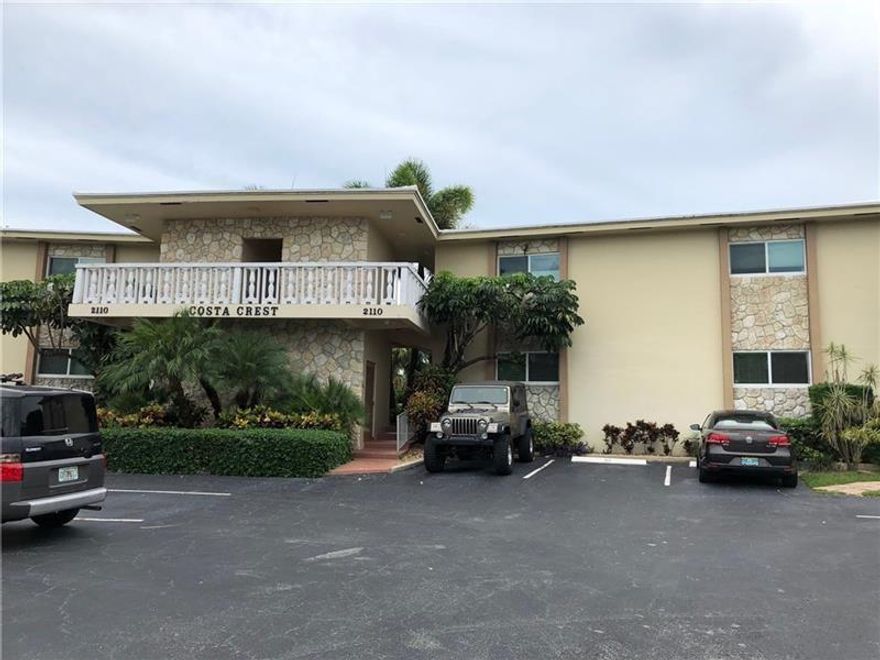 Condo is being sold AS-IS. OK TO LEASE THE FIRST YEAR. Tenant occupied with long term lease. First floor unit with high impact windows and doors. New AC & Hot Water heater, bathroom remodeled, laminate flooring, semi-open kitchen. Costa Crest is a cozy, boutique building in the Coral Ridge area of only 20 condos. Walk to Fresh Market, LA Fitness, restaurants, shops, bus route, easy highway access.  The beach is very close, short bike ride via Oakland Park or Commercial Blvd.