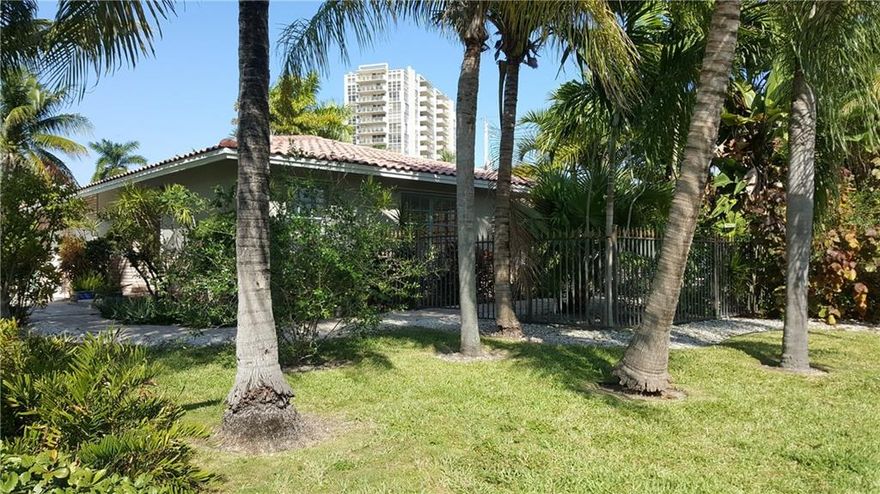 Two homes under one roof in residential beachside community of Dolphin Isles.  The main house offers an open layout featuring an updated galley kitchen, two master suites and spacious entertaining areas. The guest house is complete with kitchen, master suite and livingroom.  Other features:original terrazzo floors, french doors, double garage. Spacious & private corner lot with paved patios, lush landscaping and pool.  Real tropical feel! Steps from Fort Laud Beach and Birch Park, Bayview School District.