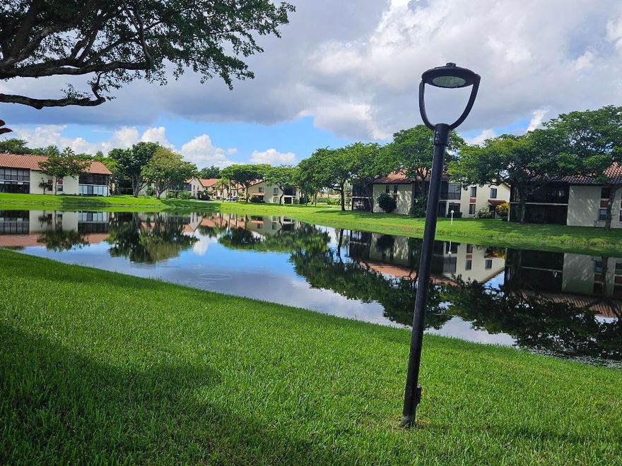 Now available in the gated 55+ community of Palm Chase. This beautiful 2 bed, 2 bath condo is incredibly spacious and offers an oversized screened-in patio with breathtaking views of the lake. There's ample living space with a large living room, separate open den/office, dining room and an eat-in kitchen. The master bedroom features a walk-in closet, a standard closet, and an en-suite bathroom with a walk-in shower. The entire unit has newer luxury vinyl flooring throughout and newer stainless steel appliances. There's a full washer and dryer located inside the unit as well and a newer A/C. Water and basic cable included. No pets per association - ESA and service animals are welcomed. Palm Chase is a premier 55+ community offering a heated salt water pool, hot tub, clubhouse, auditorium, and tennis courts with many clubs, activities and social events.