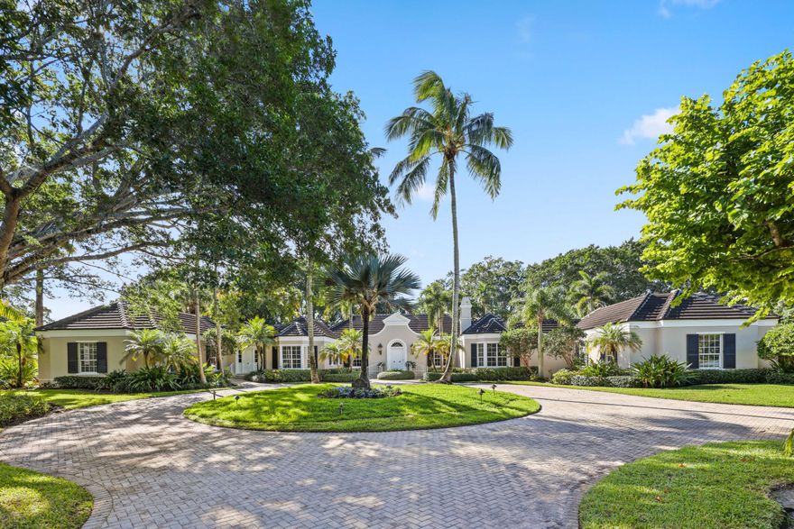 Discover unparalleled elegance and timeless charm in this stunning 6-bedroom, 6.1 bath estate nestled on 1.82 acres in the prestigious Village of Golf. Offering 6,761 total square feet and 5,665 living square feet, this meticulously maintained home seamlessly blends classic sophistication with updated amenities.
Elegant steps lead to the stately front door, opening into a gracious foyer that flows seamlessly into the grand living and great room. Here, soaring tray ceilings, refined archways, and an expansive wall of sliding glass doors create a sophisticated backdrop, unveiling a picturesque patio and pergola with landscaped privacy and tranquil golf course views. Designed for elegant entertaining, the formal great room offers distinguished living and dining spaces, while the charming garden room, complete with a wet bar, enhances the home's warm and inviting atmosphere. The eat-in kitchen boasts granite countertops, a spacious pantry, and top-tier appliances and leads to an inviting family room with a cozy fireplace and built-in bookshelves. A stately den with sliding pocket doors offers the ideal private retreat.
The expansive primary suite features a charming bay window, an oversized bath, and generous closet space. A thoughtfully designed guest wing includes two guest bedrooms, each with en-suite baths and walk-in closets, while a separate entrance ensures privacy for visitors.
Additional highlights include impact glass windows and a generator for peace of mind, wood floors throughout, 5 AC units & 2 hot water heaters for optimal comfort.
This exceptional golf course estate presents an extraordinary opportunity to enjoy privacy, elegance, and the ultimate South Florida lifestyle. Schedule your private tour today!