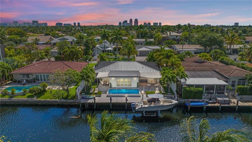 Idyllic waterfront living awaits you in this exquisitely updated three-bedroom home in coveted East Wilton Manors. Bright and open interior highlighted with high-end finishes and tranquil water views. The sophisticated open kitchen features an impressive large quartz waterfall island that's perfect for entertaining. Notable upgrades include beautifully restored Terrazzo floors, bathrooms, custom closets, impact glass, AC, electric panel, custom landscaping, LED lighting, new aluminum roof, and so much more. Outside you’ll find paradise on par with the best resorts; dual covered patios, tumbled marble pavers, sparkling saltwater pool, gorgeous dock with 10,000 lb boat lift, and maintenance-free synthetic grass. *Effective Sales Price $1.575M ($1.475M sale +$100K retained from previous deal)