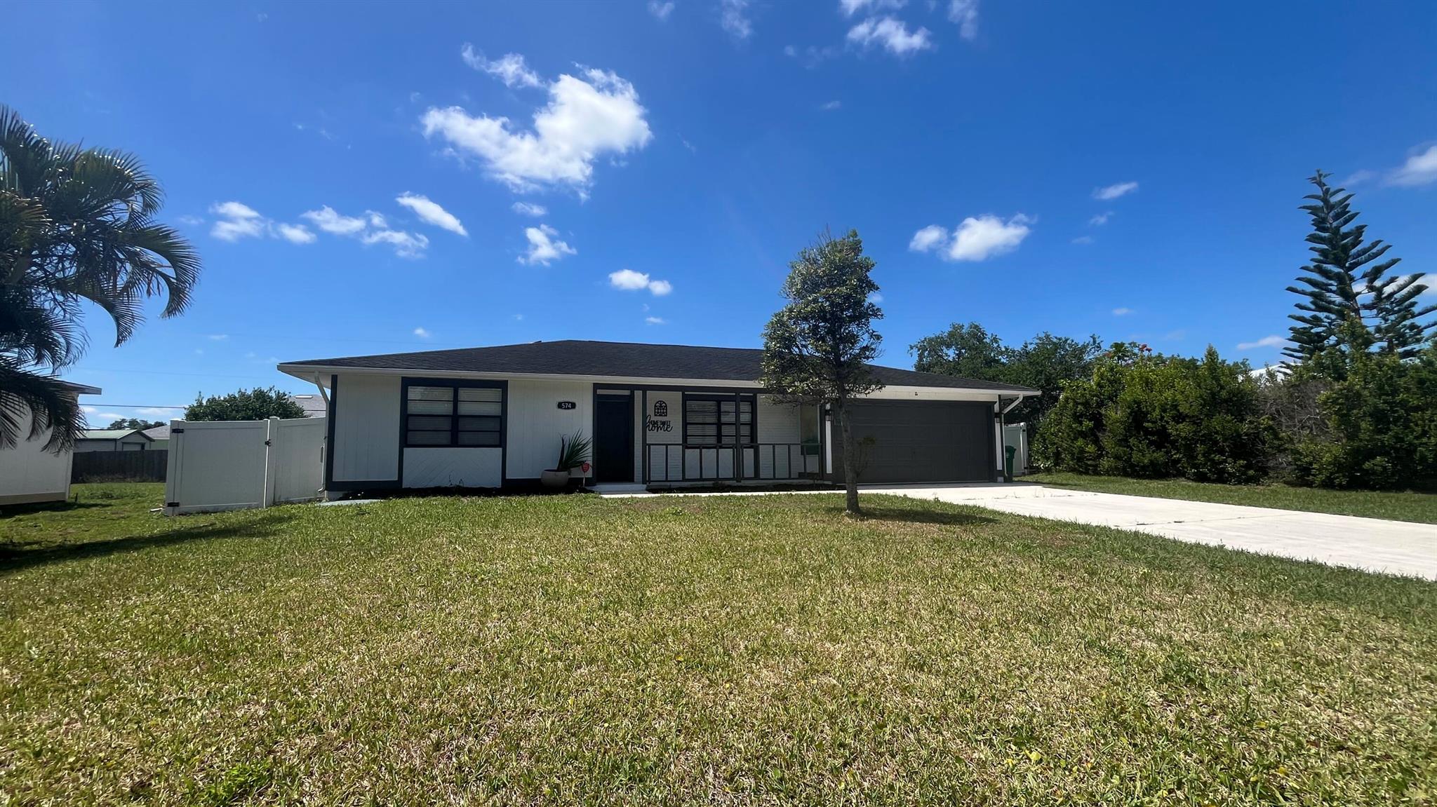 Beautiful single family pool home in the heart of Port St Lucie with updated 3 bedroom 2 full bath 2 car garage. Freshly updated kitchen with stainless steel appliances buffet island and open for entertaining. Great laminate flooring throughout the home. Private screen enclosed Lanai with pool, tropical setting & fenced in yard.. No HOA so bring your boat and toys with no problems. Close to shopping, turnpike & St Lucie River. This home is in Move In condition ready for a new family.