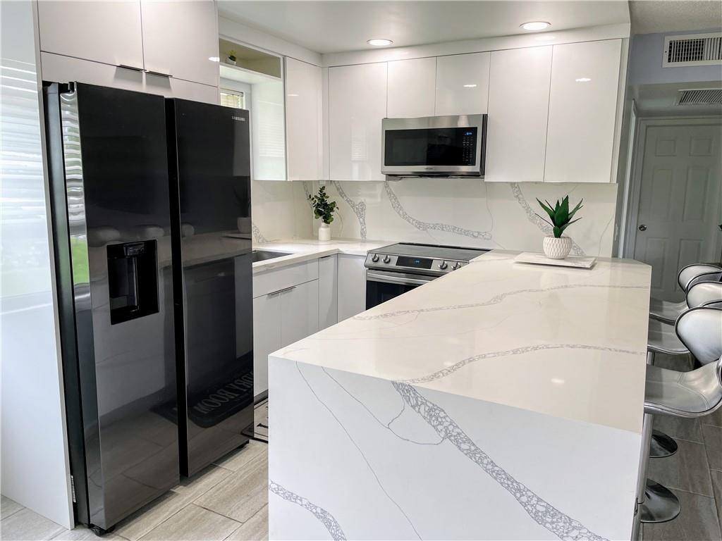 Move right into this beautifully renovated condo in the desirable gated 55+ community of Century Village. The open-concept kitchen impresses with stainless steel appliances, oversized countertops, and modern finishes. Tile flooring flows throughout, leading to an enclosed balcony with sliding windows—perfect spot for enjoying evening breezes.
Century Village delivers an unmatched lifestyle with association fees covering insurance, cable, water, courtesy bus service, and access to countless amenities. Residents enjoy indoor and outdoor pools, a clubhouse, fitness center, tennis, pickleball, shuffleboard, ping pong, billiards, cards, a theater, library, and more.
With rentals permitted, this condo is both a perfect place to call home and a smart investment.