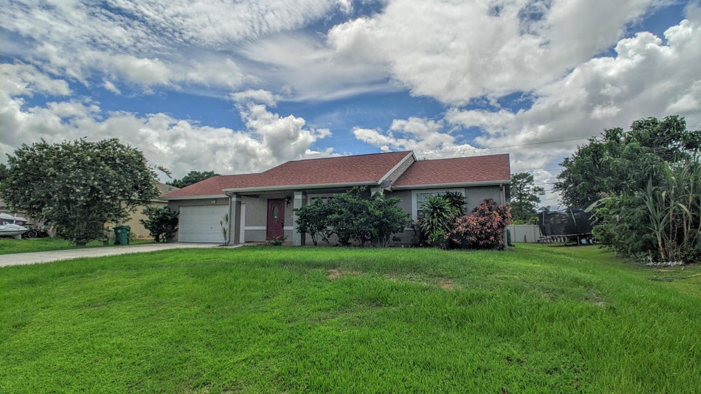 Photo of 1858 SW Davis Street, Port Saint Lucie, FL 34953 (MLS # B26039200)