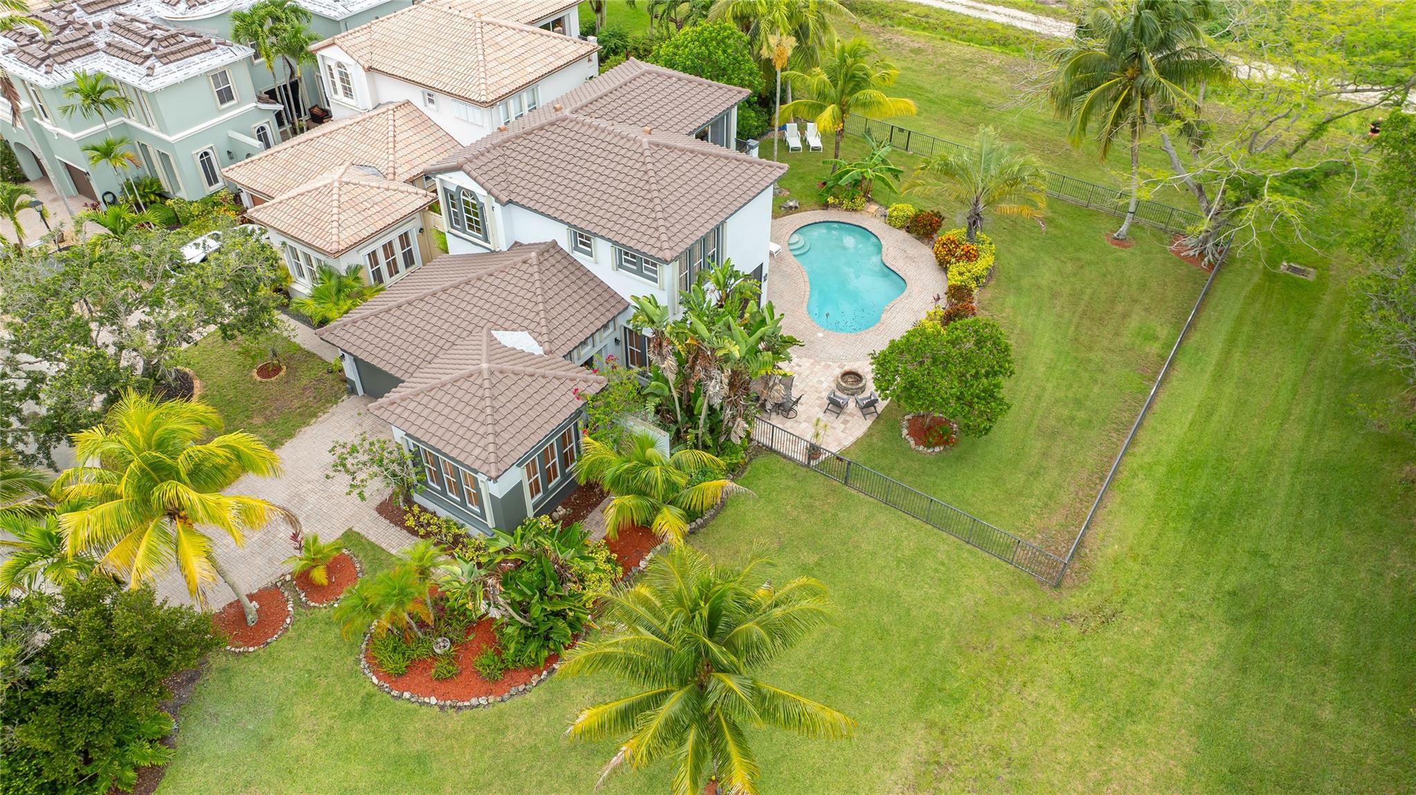 Welcome to your own private retreat! This beautifully updated 4-bedroom, 2.5-bath home is nestled on one of the most expansive & picturesque lots, offering breathtaking sunset views over the Everglades, a serene “green ocean”. Lakefront & Preserve Views make this a Stunner ! Enjoy peace of mind with a brand-new roof installed just three months ago & a freshly painted exterior. The Flexible fourth bedroom is conveniently located on the first floor & currently serves as a dual office space. The kitchen has been tastefully updated & All bathrooms have received a refresh. Upstairs, you’ll find The Primary Suite & 2 additional bedrooms + Loft Space.
Step outside to your own tropical paradise - screened patio, open pool, enormous fully fenced yard, & large patio with cozy fire pit -Just Wow