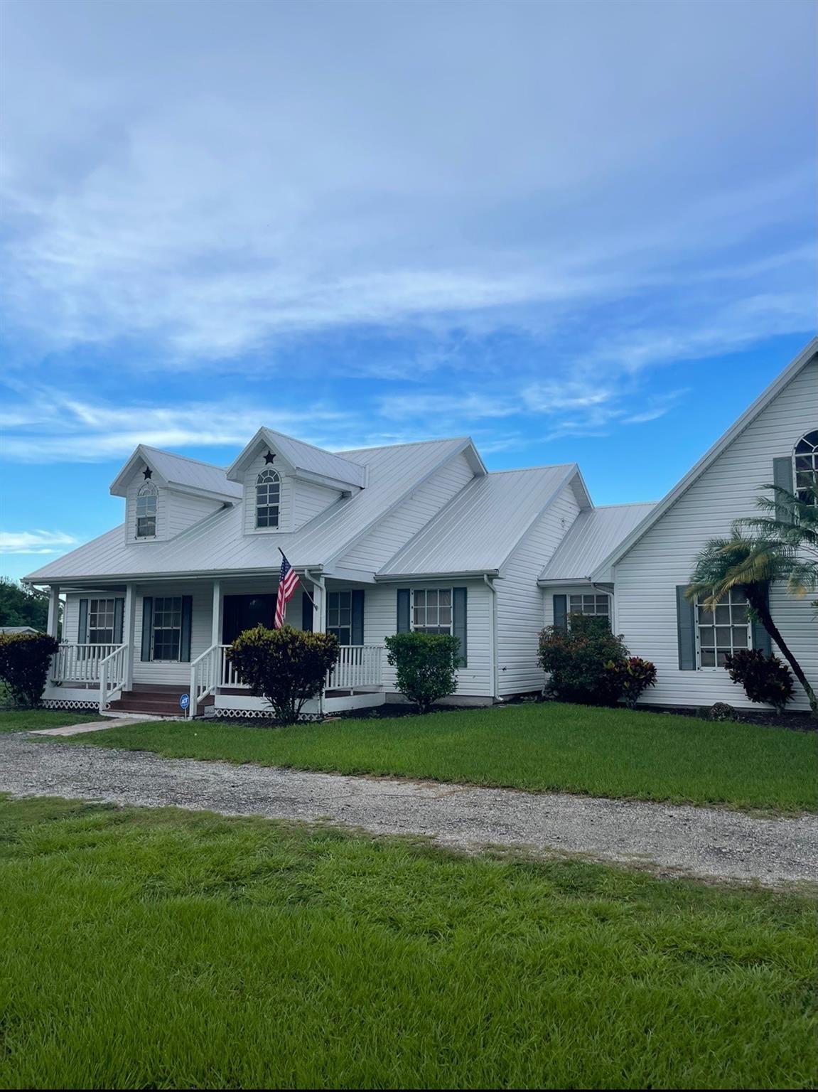 Experience the charm of country living with the convenience of city proximity! This property is surrounded by other homeowners with at least 2 acres but close enough to the city to enjoy Okeechobee's fast-growing economy. Only 1 mile from city limits and set on nearly 3 acres, this concrete block ranch-style home exudes comfort and elegance. The spacious open concept living and kitchen area feature a bay window, hardwood floors, and French doors, while the dining room adds a touch of sophistication. An upstairs room is ideal for a 4th bedroom, office, or recreation/exercise space. Also included are 2-car garage, metal carport, and water softener with all new well equipment. Enjoy a 24X48 3 stall horse barn with additional room for a tack room or 4th stall, and NO HOA. Welcome Home!
