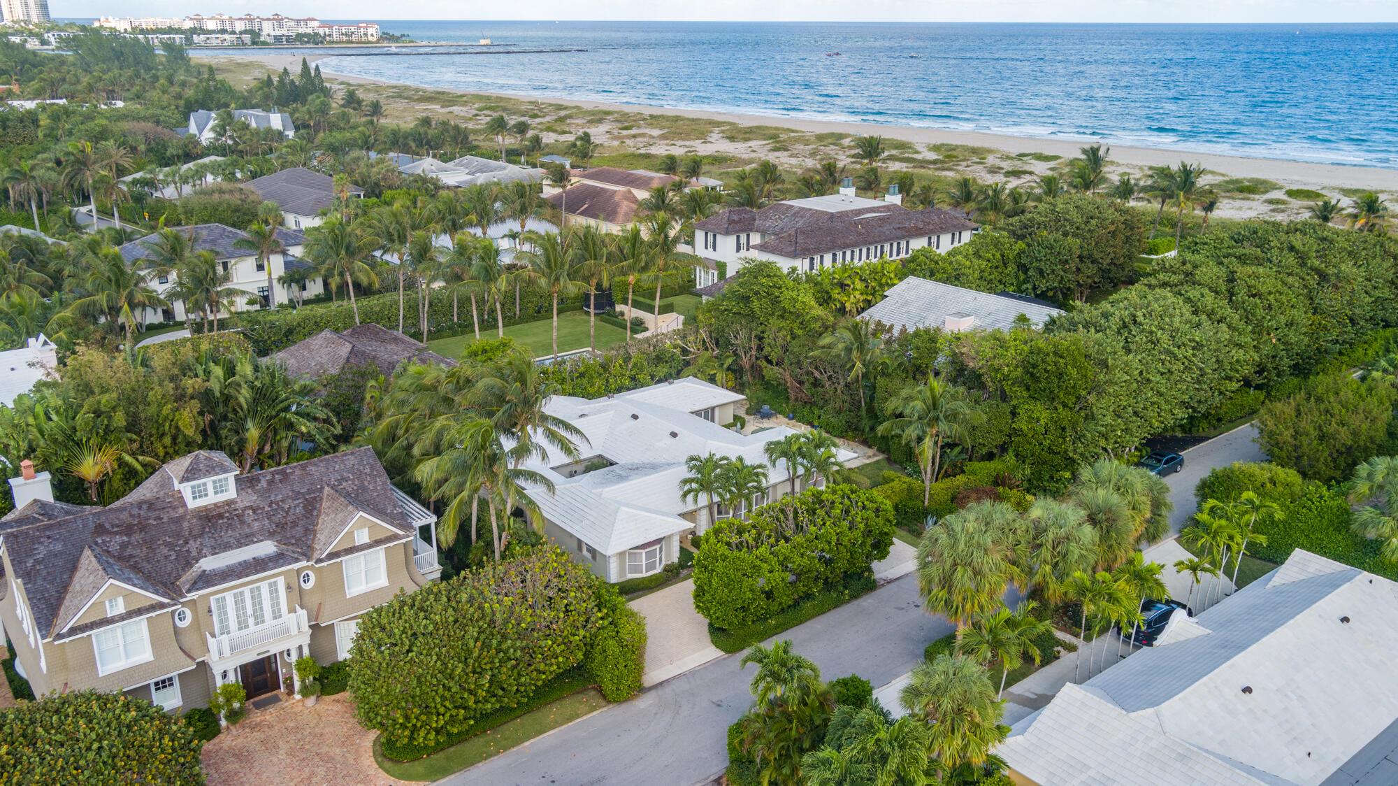 This charming Bermuda style home is a rare find, located just two parcels away from the ocean on the highly desired North End of Palm Beach. Situated on an oversized 12,200 square foot lot, this property provides ample space for outdoor entertainment and potential expansion. The proximity to the beach is a major highlight, with the best beach cabana on the island just a couple hundred feet away.