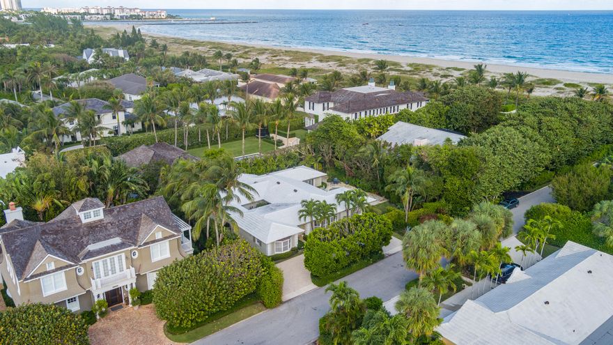 This charming Bermuda style home is a rare find, located just two parcels away from the ocean on the highly desired North End of Palm Beach. Situated on an oversized 12,200 square foot lot, this property provides ample space for outdoor entertainment and potential expansion. The proximity to the beach is a major highlight, with the best beach cabana on the island just a couple hundred feet away.