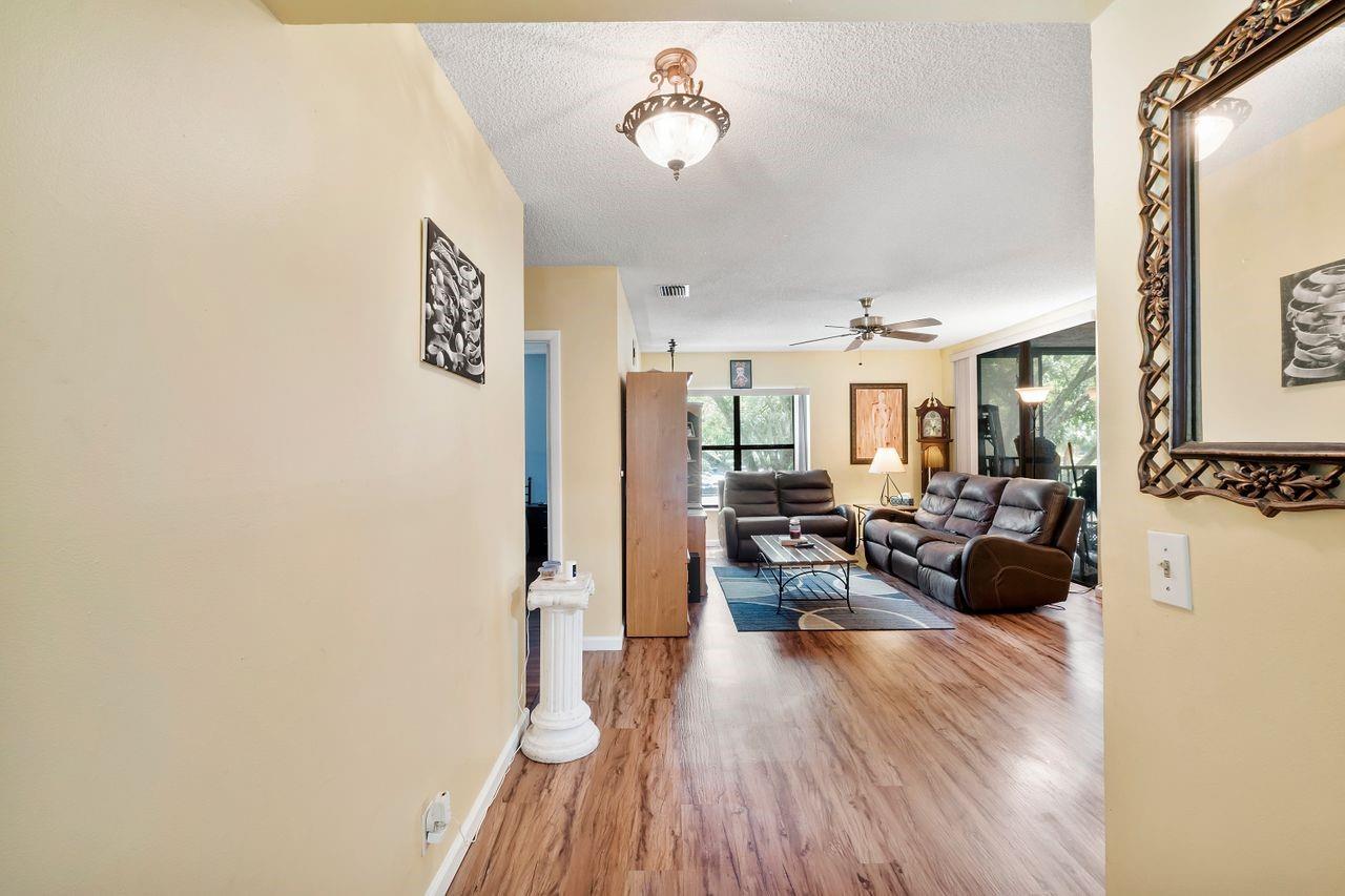 Prime location in Coconut Creek in Bayview Village III. 3 bedroom, 2 full bath large condo home with updated flooring, with over 1100 sq. ft of living space! New Roof was just completed, community pool, private parking space and guest spaces too. Pet friendly with washer and dryer hook up in the condo. The condo has a newer AC unit only 3 years old and complete hurricane shutters, the patio is screened in and is enclosed with glass sliders. The kitchen has updated stainless steel appliances and combined dinning room/family room perfect for entertaining. The primary bedroom has a large walk in closet with vaulted ceilings. HOA Includes outside pest control, lawn and community maintenance, community pool, water, roof, insurance and basic cable.