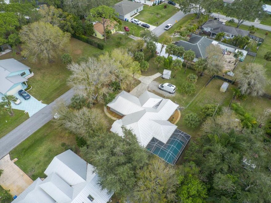 Comfortable house on super high double lot on a quiet street. 2023 completely remodeled heated pool w/ new heater, pump, filter & no-see-ems scrns, 2020 metal roof and gutters, two AC, whole house generator with 500 gal tank, easy to put on hurricane shutters, updated sprinkler system with new pump, heads/cntrls & updated indoor plumbing. Huge master suite with plenty of closets and additional room that could be a nursery, 2nd walk in closet or office. Split floor plan, large laundry/mud room with utility sink. Two sheds for extra storage, fenced in section of back yard. Large garage.NO HOA.