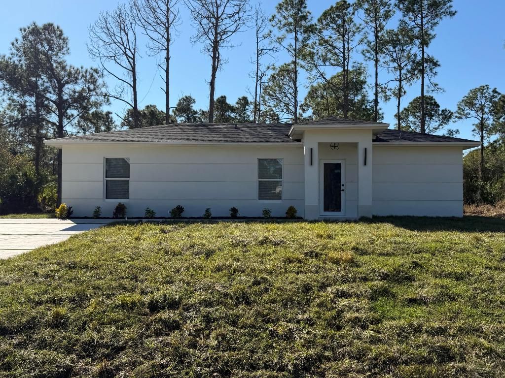 Photo of 1120 Ravenswood Street E, Lehigh Acres, FL 33974 (MLS # R11158185)