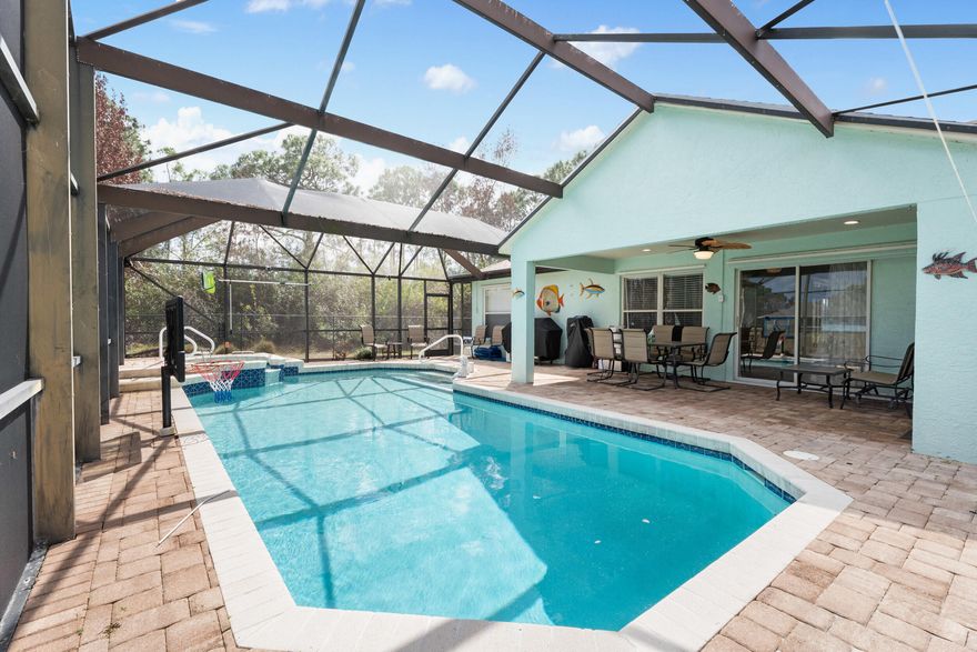 In a market where private pools are a premium, this CBS-built home in Torino delivers a secluded oasis backing onto a wide canal. Enjoy your screened patio and the sounds of the hot tub as it cascades into your solar heated pool with a 6ft "deep end" and a gas heated back-up. This 3BR + Den/Office (with plantation shutters) features over 2,000 sq ft of carpet-free living space and a brand-new 2023 roof for maximum insurance savings. The kitchen boasts solid wood cabinets, granite, black stainless appliances, and a gas stove. Retreat to a renovated primary en suite featuring 24×48 porcelain tile, a clawfoot tub, and a walk-in shower. Walk-in closets in the primary and second guest suite.  Complete hurricane protection, including porch screens, ensures total peace of mind in this premier location with no HOA! Additional features include a second permitted grass driveway, fully fenced backyard, and well sprinklers on the sides and rear of the house.