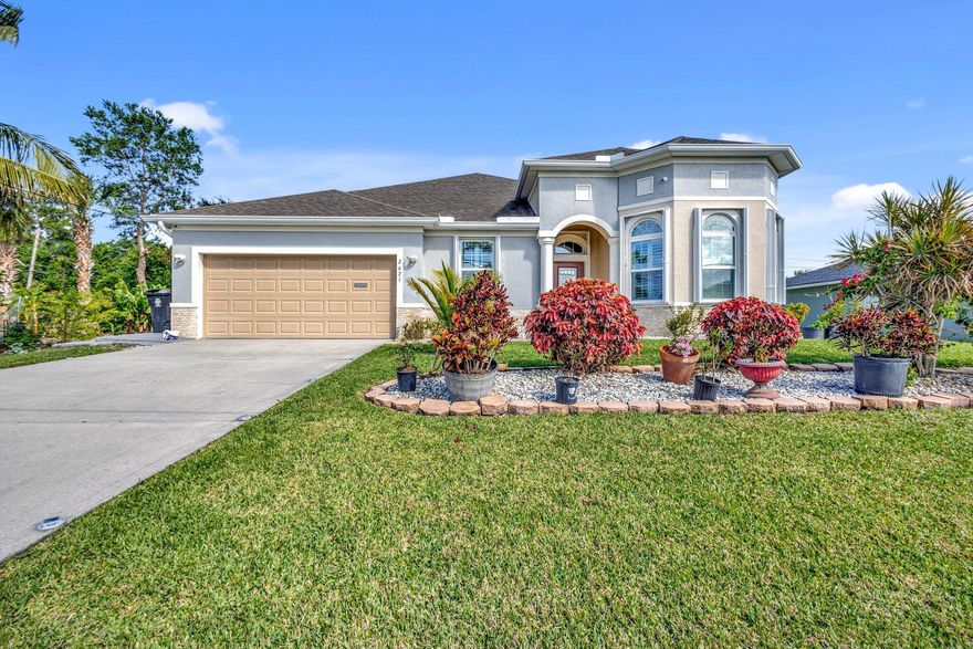 Welcome to your private paradise! This luxurious 5BR/3BA + den pool home on 1/2 acre features vaulted ceilings, crown molding, bamboo & tile floors, granite kitchen with island & SS appliances, and a stunning master suite with marble shower & quartz vanities. Enjoy a screened solar/electric heated pool and spa plus an adjacent fruit-filled lot (banana, mango, plantain, breadfruit, ackee & more) that can be split. Currently an active Airbnb with bookings into next year! Prime Gatlin location--2 min to Super Walmart & Sam's, 4 min to Home Depot, 5 min to Tradition Hospital & more!