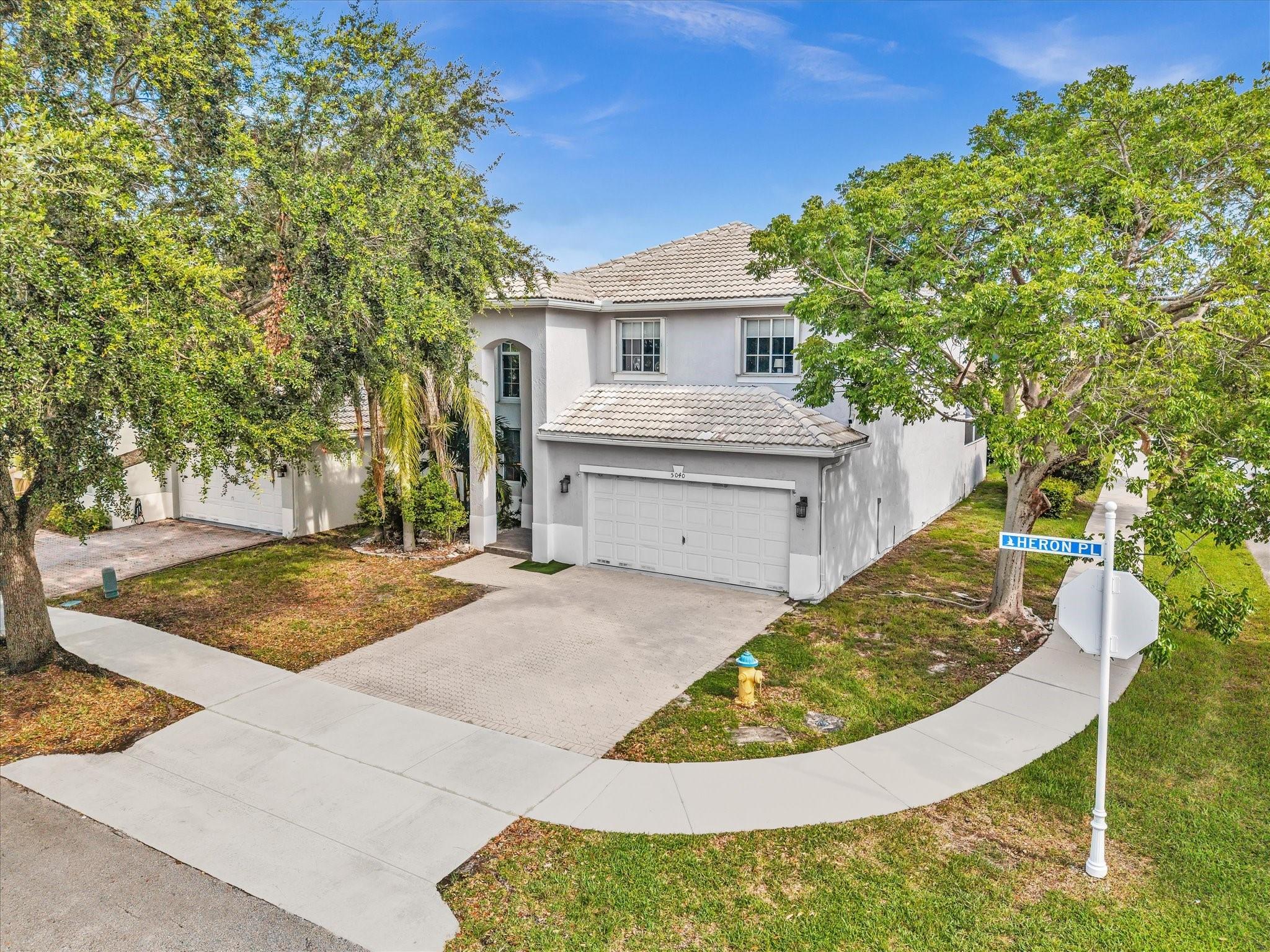 This exquisite 4 bedroom, 2.5 bathroom corner lot home is in the highly desirable Regency Lakes community. The screened lanai pool provides the perfect setting for relaxation and entertaining. A brand new roof and two car garage enhance the value of this property. Enjoy access to amenities such as tennis courts, pickleball, clubhouse, and pool with a low HOA. The open concept layout and upgrades make this home a standout choice for year-round enjoyment. With high ceilings and recessed lighting, the interior is bright and inviting. The oversized primary suite features a high ceiling and large walk-in closet, en suite bath with soaking tub. The upgraded kitchen is a chef's delight. This home is ideal for both indoor & outdoor entertaining, a must-see for buyers seeking a luxurious lifestyle.
