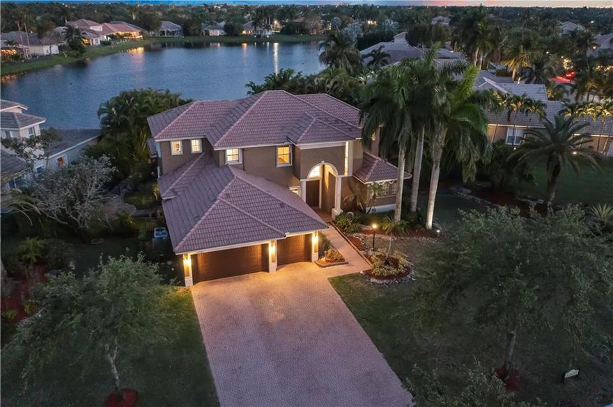 Paradise In Parkland! Parkland Isles Bayside Estates 6 Beds, 4 Full Baths + Loft/Built-In Recreation Room Custom Heated Pool & Jacuzzi Home, Tiki Hut w/Waterfall & Full Bar, Stools, Sink, & Refrigerator, 2 Additional Waterfall Features By Pool w/Computerized Pentair System Which Controls Heat Temperature & Waterfalls. Home Sits On An Oversized, Corner Pie Shape Lot Under 1/2 Acre Directly On A Lake w/Marble Pavered Patio & Side Patios w/Lots Of Extra Space On Each Side, Gorgeous Tropical Oasis Landscaping Throughout, Accordion Shutters On All Windows & Sliding Doors, Master Downstairs w/Sitting Area Overlooking Back Patio Oasis, Separate Full Bed & Bath Downstairs, Accordion Hurricane Shutters, 4 Beds Upstairs Including Bed w/On-Site Full Bath, Resort Style Amenities, Schools, Won't Last!