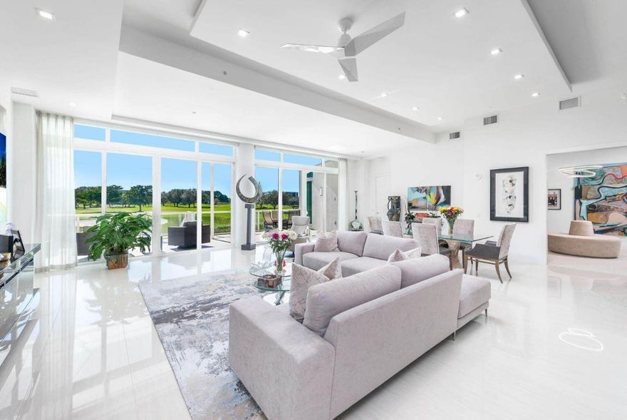 Fabulous Villa 2/4.5 plus Den & Media Room with 12' Ceilings, stunning golf & lake views & 3 garage parking spaces!! This 3,600sf+  lobby level residence flows like a single family home.  Enjoy the expansive 33' terrace with retractable awnings & a walk out overlooking the 18th fairway! Wolf & Sub-Zero appliances, quartz counters, ItalKraft cabinetry, 12' floor-to-ceiling impact windows, valet parking, 24-hour attended lobby, card room, social party room, fitness center, resort style pool & more! Located in the #1 Private Residential Country Club in the Nation, Boca West offers over 400,000sf of amenity space, an award winning spa, aquatics/fitness center, 10 restaurants, four 18-hole golf courses designed by Palmer, Fazio & Dye, 27 court USTA tennis facility, 14 pickle ball courts & more