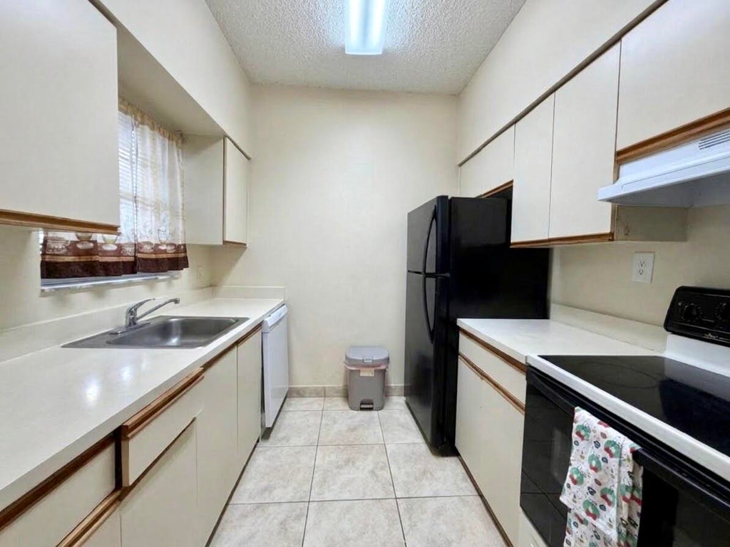 Photo of 661 Cypress Club Way #F, Deerfield Beach, FL 33064 (MLS # B26092968)