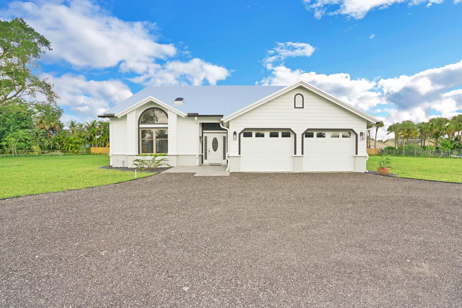 Welcome home! Recently updated four bedroom home on a private one acre lot in the desirable Ranchettes community. This home offers a first floor master bedroom with brand new en-suite bath, newly updated kitchen with quartz countertops and new appliances, brand new duel AC systems, plus three additional, nicely sized bedrooms plus an upstairs loft. Additional updates include new front door and garage doors, all new bathrooms, freshly painted interior and exterior and new roof. Located minutes from the Equestrian show grounds and a variety of shopping and dining options in Wellington No HOA so boat or RV parking is available too!