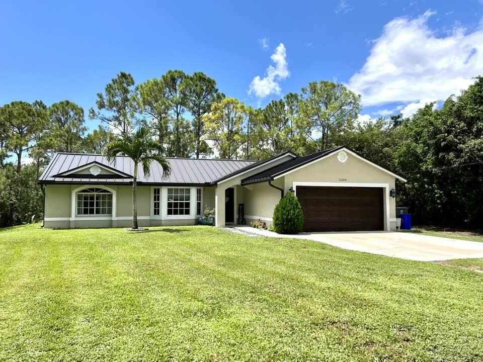 Fantastic Buy!! Newer 3 yr old roof, new AC, new tile flooring, new paint, all new light fixtures, Air ducts all recently cleaned , new gutters, totally remodeled with a stunning kitchen and master bath. Huge yard with over an acre fenced. Large screened in back porch This house will not disappoint and is extremely well maintained. Tons of room for trucks , RV , Boast etc. Great location, and close to Wellington, 30 mins to Palm Beach, the beach, and a major airport,.