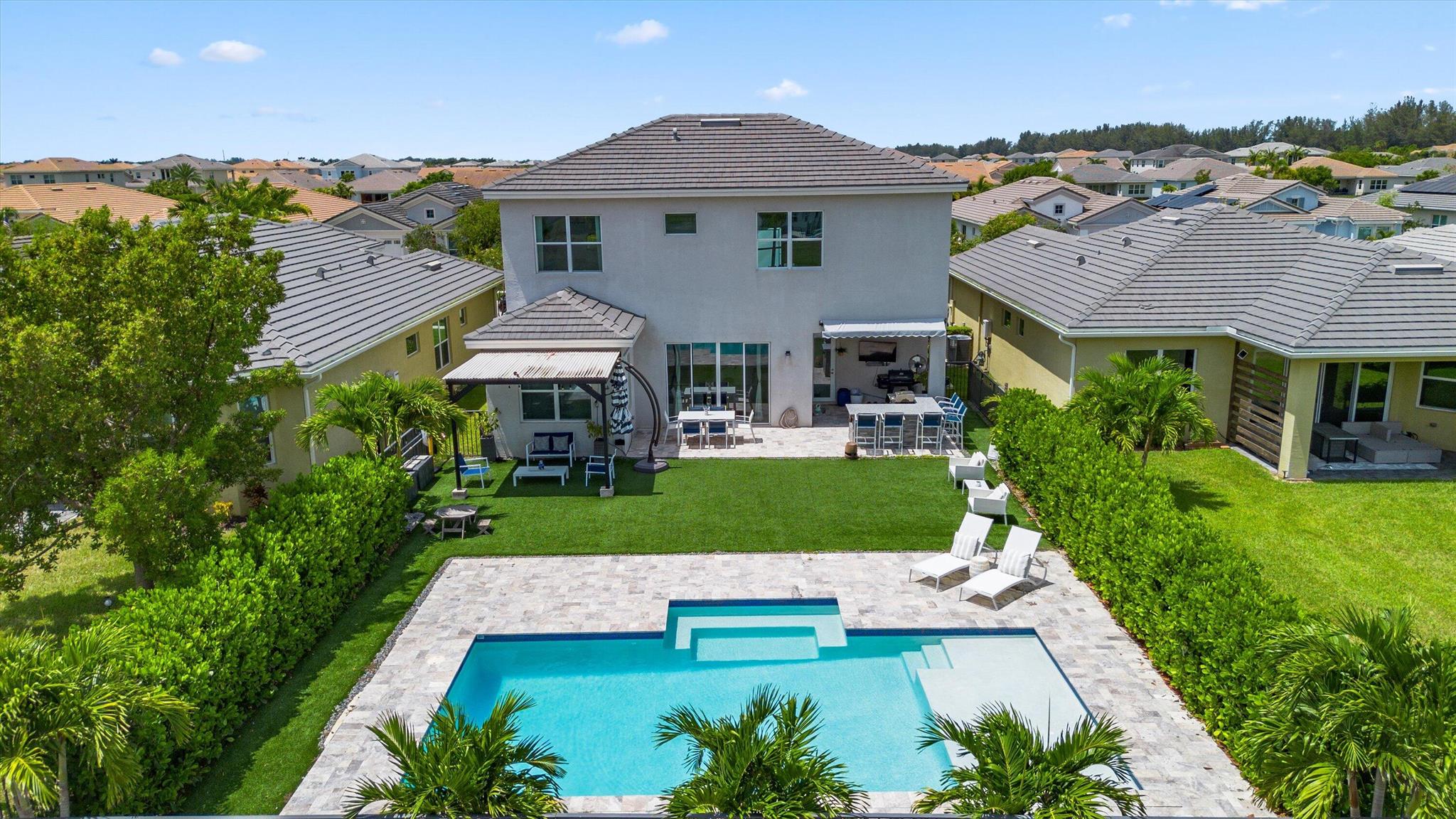 Experience luxury living in this Sycamore Model home, located in the prestigious Meadows community of Westlake, FL. This 4-bedroom, 3-bathroom residence with a versatile den and a rare downstairs bedroom with full bath offers the perfect balance of style and function. With 2,165 sq. ft. of living space and a 2-car garage, this home is built for modern comfort and comes complete with full impact windows throughout. The private backyard oasis showcases a sparkling pool, an extended covered lanai, and a fully equipped outdoor kitchen ideal for entertaining family and friends.