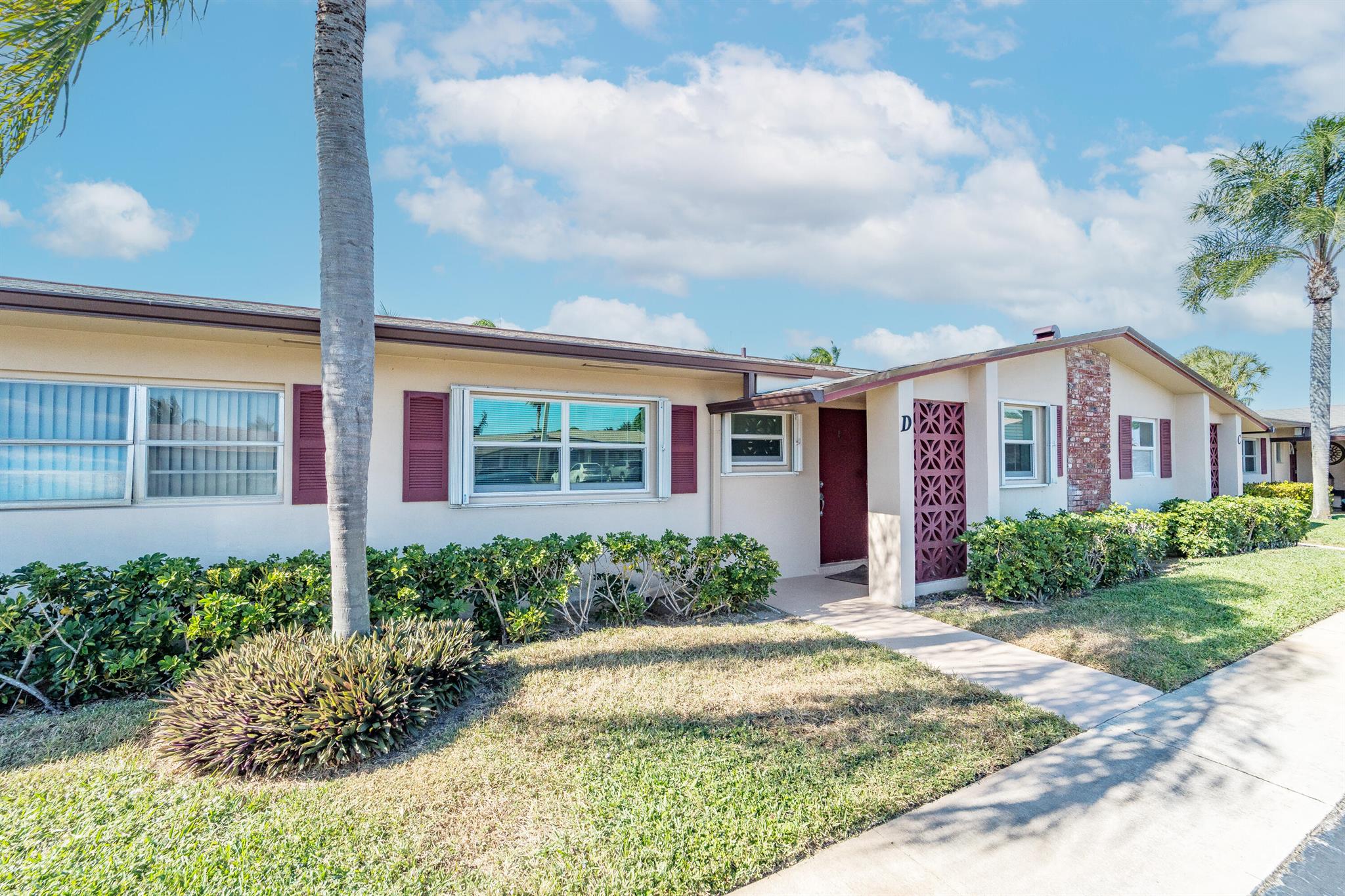 Updated, well maintained 2 bedroom, 2 bathrooms, furnished Townhouse Villa, with Hurricane Impact windows and accordion type shutters. The condo has classic crown moldings, tile and laminated wood floors, no carpets, glass-top stove, new refrigerator and new dish washer, located across the street from the clubhouse in a 55+community. New inside electric panel, new roofs, with assigned parking directly in front of the unit. The Master bedroom features ensuite bathroom with walk in shower, tub and shower in guest bathroom, large closets and storage throughout the condo. Low monthly maintenance, which includes internet, cable, water, garbage, onsite laundry facilities with assigned laundry time. The condo has an adjacent tiled patio with umbrella, BBQ, table and chairs.