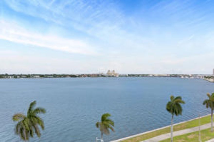 This premier east facing end unit with 180 degree unobstructed views north, east and south provides the best views in the building. (Yes, two pets are allowed). In addition, you will also have a clear view looking over the Island of Palm Beach to the ocean where you will delight in the breathtaking spectacular sunrises and enjoy a glass of wine as you toast the rays of the rising moon glimmering across the ocean and intracoastal waterway directly to your sky bound nest. The bathrooms have been updated in this two-bedroom jewel, there are tile floors throughout, new A/C, new Refrigerator, and utility room with Washer/Dryer and two deeded parking places, one covered. Two pets are allowed and walking along the ''Walk/Bike'' path directly on the intracoastal is dog friendly. Access to this secure building is exceptional. There is a key activated car entry gate. Once parked in your deeded parking space you will enter the lobby where you will be greeted concierge by security desk personnel. When you enter the elevator you have your own unique elevator code which will only open on your floor and your new home. If you don't feel like parking your own car you can also use the complimentary valet service at the front door.
The amenities in the building exceed most of the other complexes in the area. The pool, a favorite resting place is well stocked with lounge chairs and the spa/Jacuzzi is an ideal spot to rejuvenate your soul. In the community area there are two general seating rooms one with a wet bar, a bar set up, sofas chairs and TV and the second room serving as a casual sitting area. Either of these rooms can be reserved on a first come basis for private parties. There is a separate Billiard/Pool room with a TV as well. For those who want to have a BBQ party, there are two outside grills also available to all residents. Lastly, for those who enjoy physical fitness, there is a well-equipped Gym/Fitness Center with state of the art treadmills, ellipticals, stationary bikes and weights.  
The benefits are many as you enjoy the view from the east facing balcony. Common sights as you look out to the captivating view of Palm Beach, the Biltmore, Historic Breakers Hotel and The Flagler Museum looking south are the wide array of birds soaring past your perch as they catch an updraft sending them on their endless glide. You will also enjoy seeing the Manatees and Dolphins as they move gently from one to another of their favorite resting spots. Common sights are the endless array of boats that will catch your attention because of their beauty. It is not uncommon to see 150 Ft to 200 Ft. motor yachts, sleek sail boats slicing through the water and power boats of all shapes and sizes. 
Located a half mile from both Palm Beach and Downtown West Palm Beach you can easily walk or ride your bike to all of the fine dining and casual eateries. Why would you live anywhere else? Come and see this outstanding waterfront apartment and appreciate how you will be able to move right in.