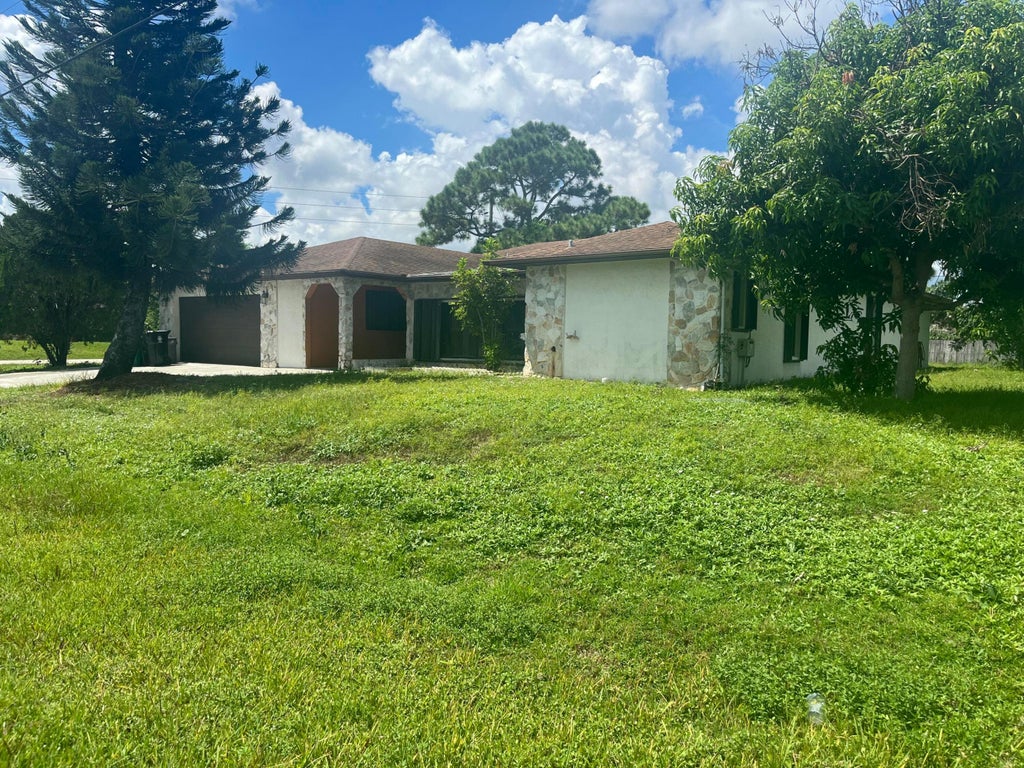 Photo of 1698 SE Manth Lane, Port Saint Lucie, FL 34983 (MLS # B26074328)