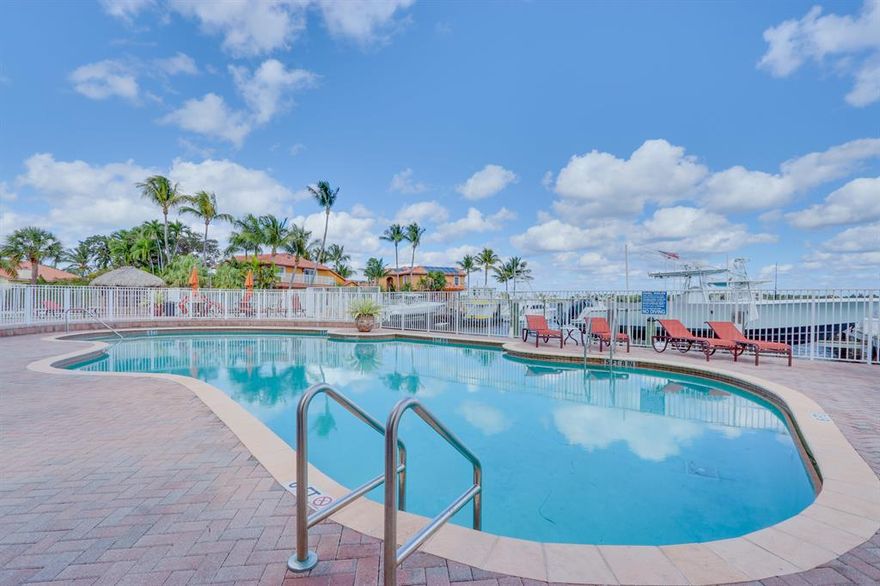 Beautiful 3/2.5 townhouse with wrap around balcony and 2 car garage. Tons of upgrades! Brand new flooring on top floor, granite countertops, stainless steel appliances, oak wood staircases. Largest unit in neighborhood and ONLY unit with a hot tub, and A/C unit for top floor, The community has a pool and dock with beautiful views of the intracoastal waterway. Can be purchased fully furnished.