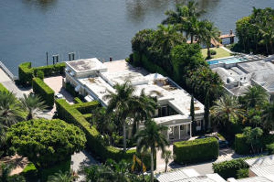 Beautiful Intracoastal and Palm Beach views from this 4BR/4.5BA regency. Fantastic location on Everglades Island. Oversized approximately 1/2 acre lot, courtyard entrance, dock with boat lift, large pool, covered loggia, and 2 car garage. Possible redevelopment opportunity.