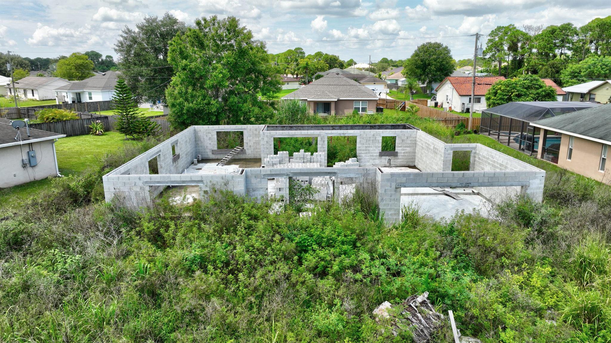 Opportunity Awaits! This partially constructed concrete block home offers a blank canvas for your vision. Seller will provide building plans. This is a 1610 Under Air 3 Bedroom and 2 bathroom with a 2 car garage home. Total Under Roof will be 2507. Nestled in a fantastic location with easy access to shopping, dining, festivals, and golfing. Don't miss out on the chance to build your dream space! Seller says plumbing has been roughed in!