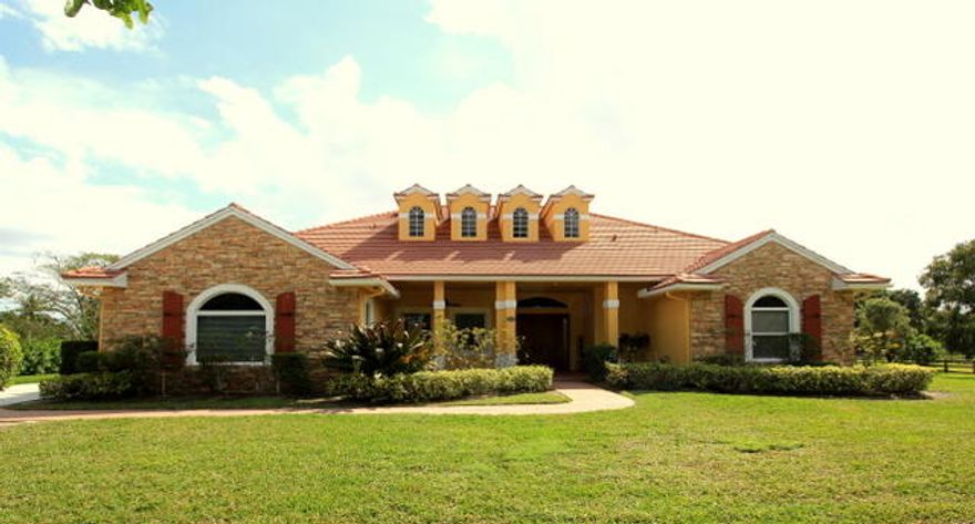 THIS CUSTOM HOME LOCATED IN AN EQUESTRIAN COMMUNITY FEATURES AN OPEN FLOOR PLAN WITH HIGH VAULTED CEILINGS AND LOTS OF NATURAL SUNLIGHT. THIS 5 BEDROOM + LOFT + BONUS ROOM HAS 90% HURRICANE WINDOWS, NEWER AC UNITS, SECURITY CAMERAS AND MORE. SITUATED ON A PAVED ROAD WITH NEARLY 2 ACRES OF LAND AND PLENTY OF ROOM FOR A BARN,PADDOCK AND RING.  LOCATED ON THE BRIDAL PATH AND HACKING DISTANCE TO SHOW GROUNDS.