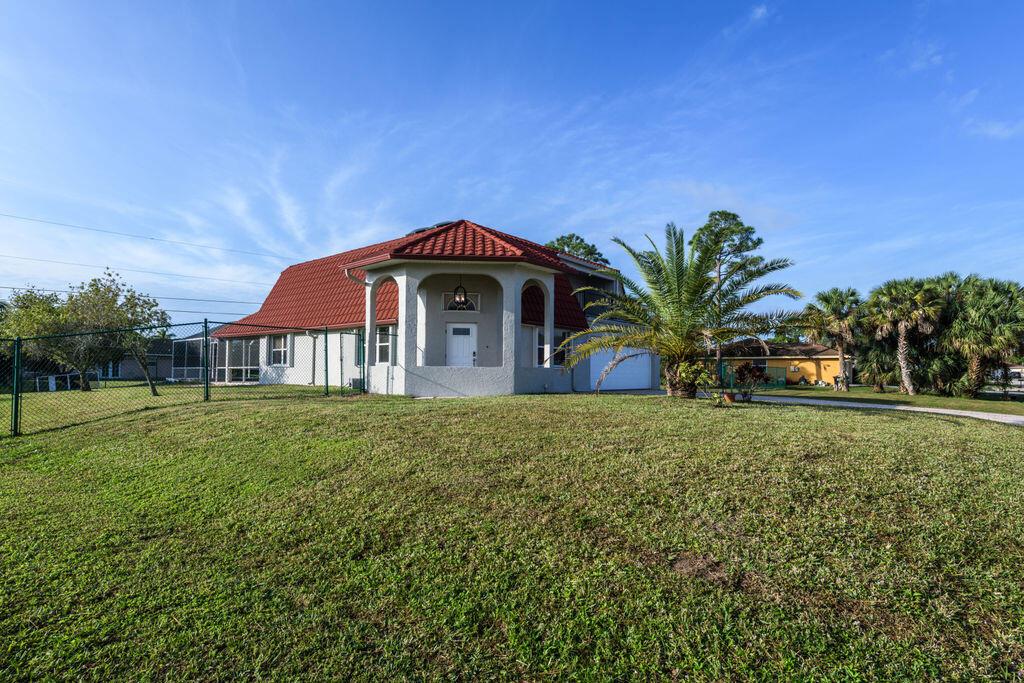 Spacious Home with Pool and No Neighbors on Either Side. Rare Privacy in Port St Lucie Spacious 3BR plus den with heated saltwater pool and spa with multi-color lights. Two fully fenced landlord-owned side lots included with the rental providing true outdoor living extra space for pets and play and no immediate neighbors The primary suite is upstairs with a large balcony while two additional bedrooms are on the main floor. The modern kitchen comes with stove, microwave, refrigerator, and water filtration system all in excellent condition. Washer and dryer are also included, and the home has freshly painted exterior and updated light fixtures. The property is offered unfurnished. Lawn maintenance, pool service, and pest control are included in rent. Pets allowed with owner approval.