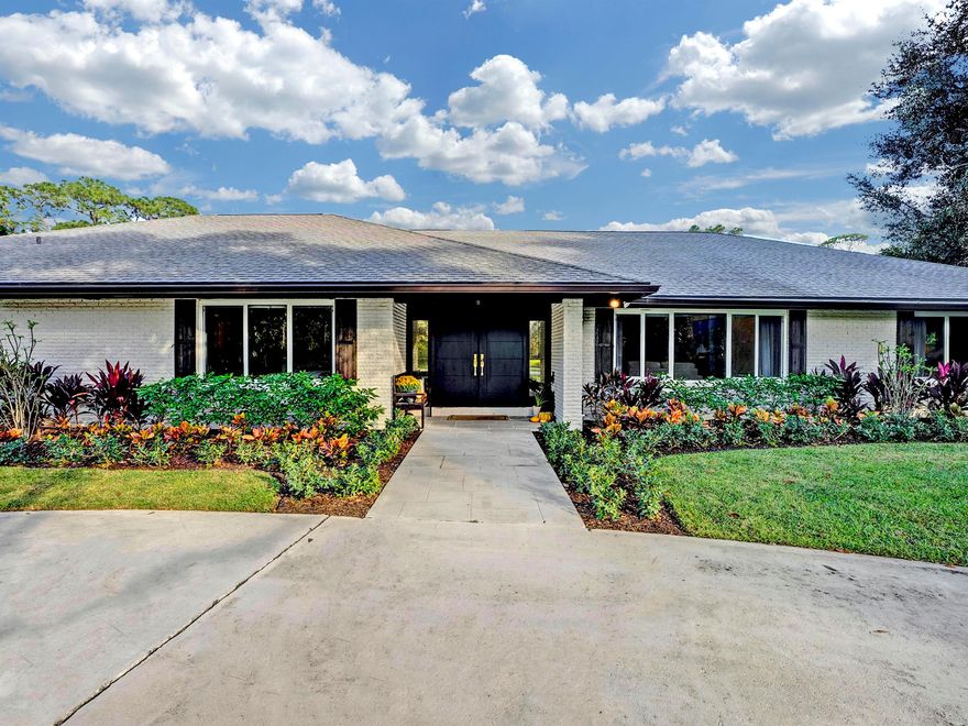 Immerse in luxury with this exquisite 4 bedroom + office, 3 bath, 3400 sqft home nestled on a pristine acre at the end of a quiet cul-de-sac in Imperial Woods. The meticulously renovated residence boasts a seamless split floor plan and captivating stately exterior. Step into elegance with true hardwood floors and high-end finishes illuminating every space. The chef's kitchen is a masterpiece, adorned with Dolomite countertops and new appliances. Hurricane impact windows & sliders throughout. Relax & entertain in the expansive living spaces. The master is a tranquil oasis with no detail missed. An oversized 2-car garage features a Polyasparic floor. Solar water heating ensures efficiency. The circular driveway and ample space off the covered, screened patio offer boundless possibilities.