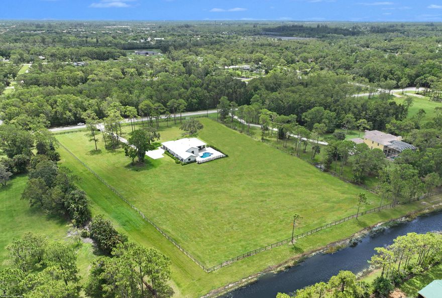 Reduced $550k! Totally renovated home from top to bottom! Perfectly situated on a cleared 5-acre lot - build your desired equestrian amenities, including a covered arena. This home boasts an open floor plan with center-island kitchen, gas cooking and quartz counter tops. The home features 4 bedrooms, 3 full baths, a large office/den, impact windows & doors, all new AC systems, reverse osmosis water treatment system and sprayed icynene insulation in the attic for energy efficiency. The pool has been refinished along with the expanded pool deck & new summer kitchen. The driveway has new entry columns and electric gate.  Situated on a quiet street in this gated equestrian subdivision and close to all of Wellington's equestrian venues. Don't miss out on this great opportunity, a must see! The Seller has HOA approved plans for a 12- stall barn with 4 wash stalls, feed, tack, kitchen and storage rooms.  Plans are ready to be submitted to the County for permit. (12 Stall maximum allowed per lot. Covered arenas and boarding now allowed).