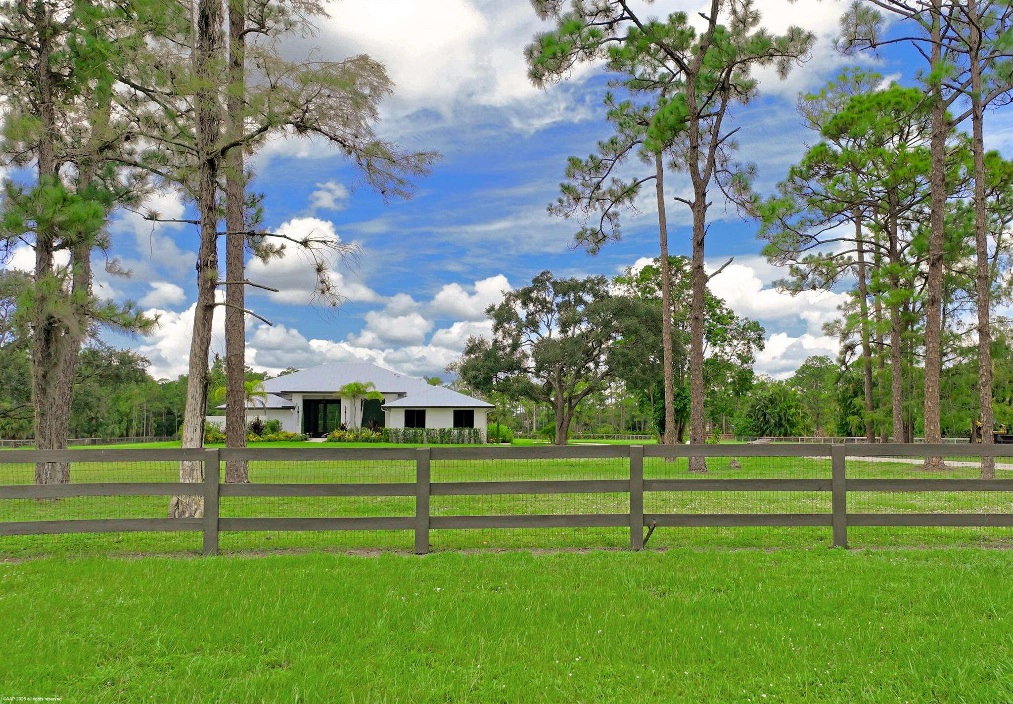 Reduced $550k! Totally renovated home from top to bottom! Perfectly situated on a cleared 5-acre lot - build your desired equestrian amenities, including a covered arena. This home boasts an open floor plan with center-island kitchen, gas cooking and quartz counter tops. The home features 4 bedrooms, 3 full baths, a large office/den, impact windows & doors, all new AC systems, reverse osmosis water treatment system and sprayed icynene insulation in the attic for energy efficiency. The pool has been refinished along with the expanded pool deck & new summer kitchen. The driveway has new entry columns and electric gate. Situated on a quiet street in this gated equestrian subdivision and close to all of Wellington's equestrian venues. Don't miss out on this great opportunity, a must see!