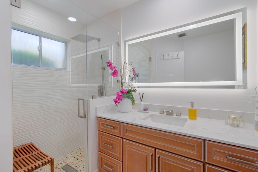 Beautifully Upgraded Corner Villa — Turnkey & Move-In Ready New roof scheduled for 2026! This bright corner-unit villa features vaulted ceilings and skylights that fill the home with natural light. The upgraded kitchen offers granite countertops, new backsplash, wood cabinetry, stainless steel appliances, wine cooler, and a coffee station. Enjoy remodeled bathrooms, a landscaped patio, and a new console A/C in the family room.